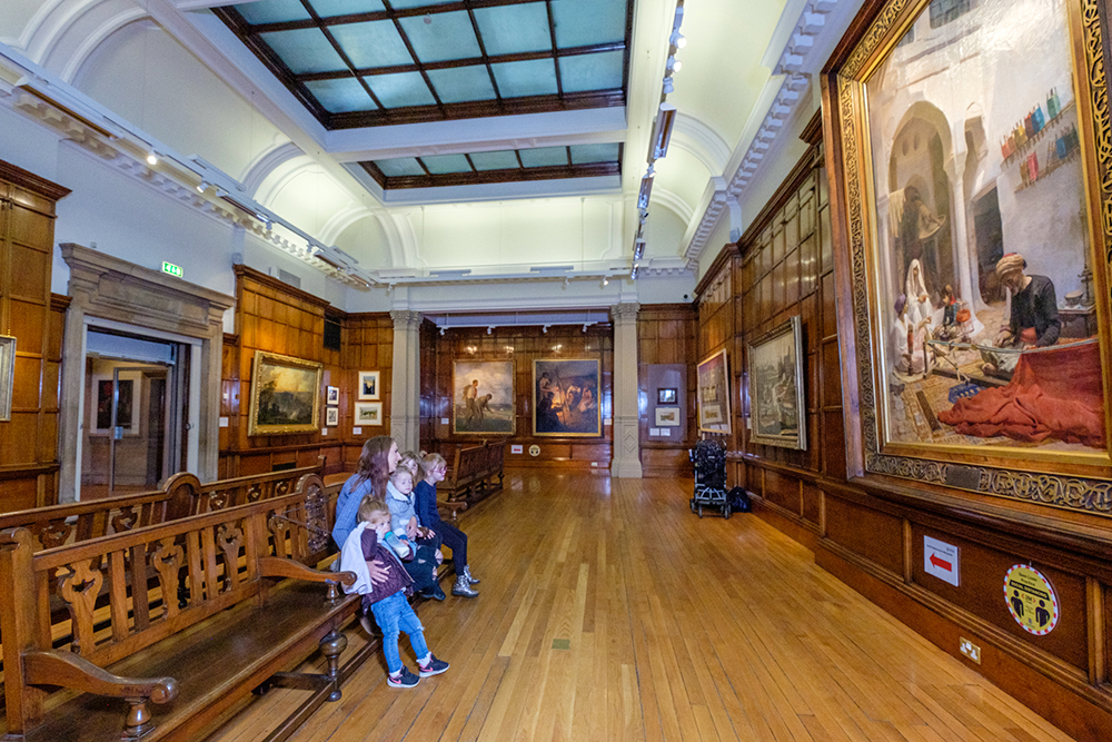 Art museum in Bradford - family looking at painting - Occupational Health Consultants