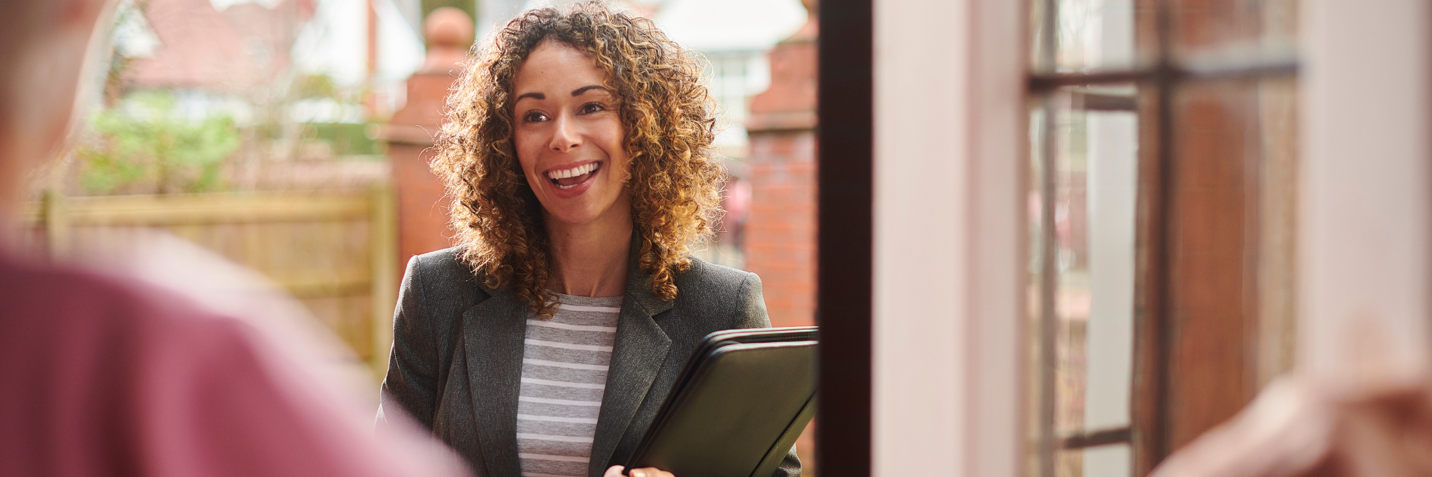 Lady smiling during conversation - Yorkshire and Humber Regional International Recruitment Hub