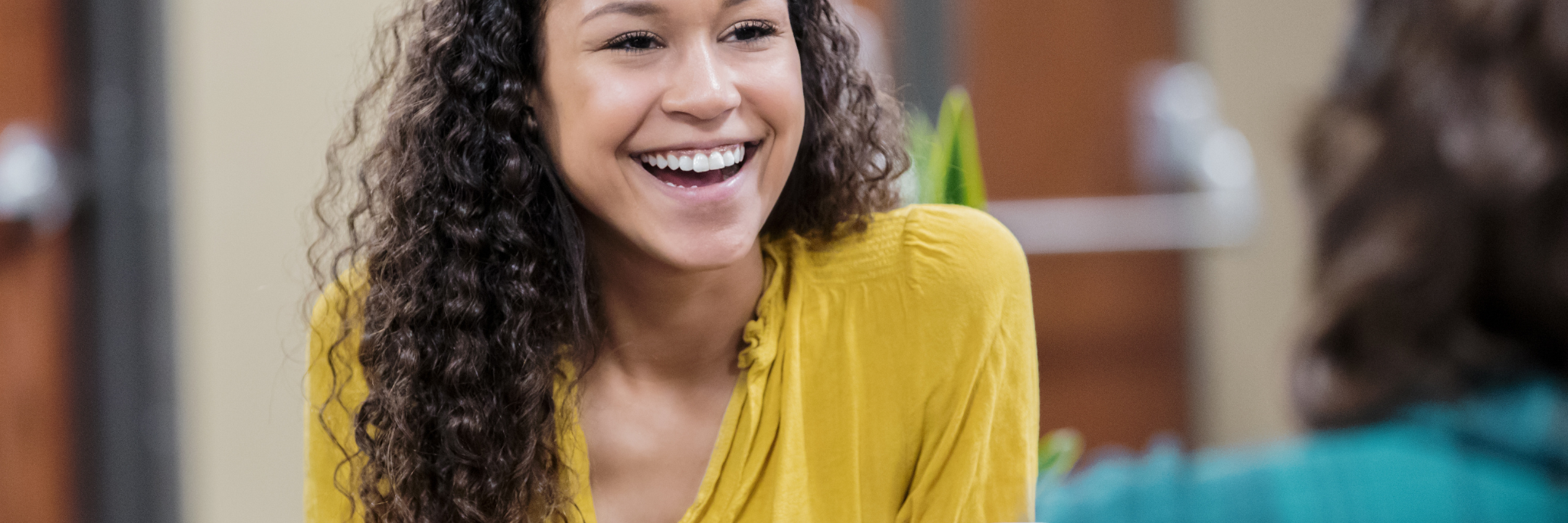 Lady smiling during conversation - Yorkshire and Humber Regional International Recruitment Hub