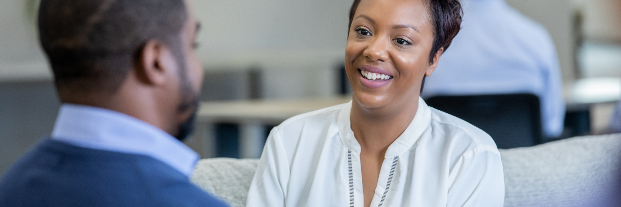 Lady smiling during conversation - Yorkshire and Humber Regional International Recruitment Hub