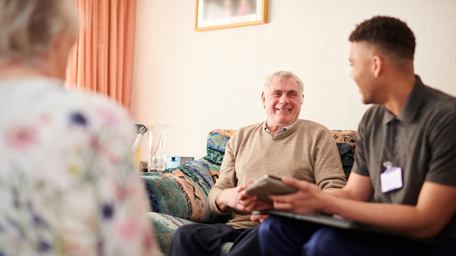 Man smiling while interacting with Social Worker - Help for all sponsored workers in Adult Social Care