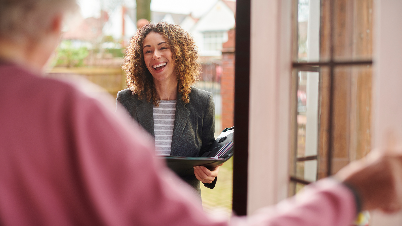 Lady smiling during conversation - Yorkshire and Humber Regional International Recruitment Hub