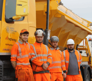 NY Highways apprentices in hi vis next to a truck
