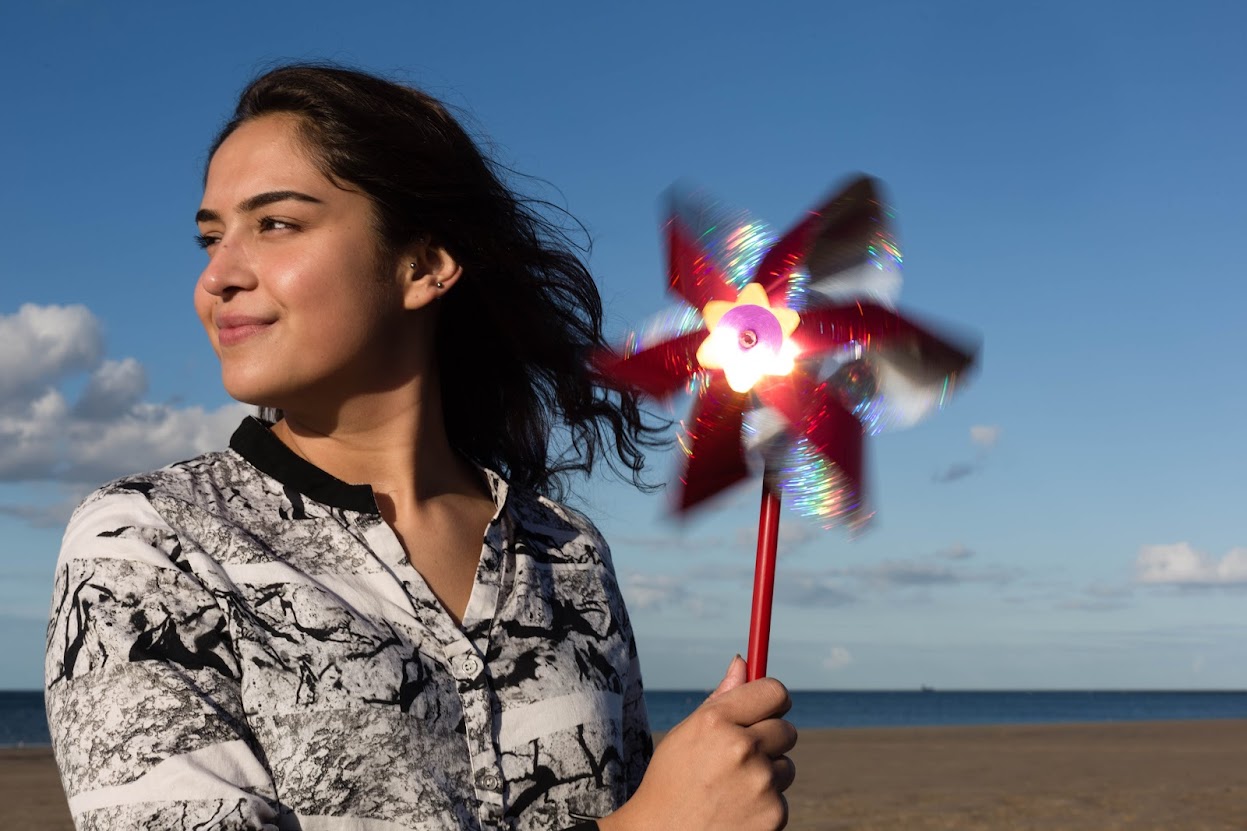 lady on Redcar beach holding fan
