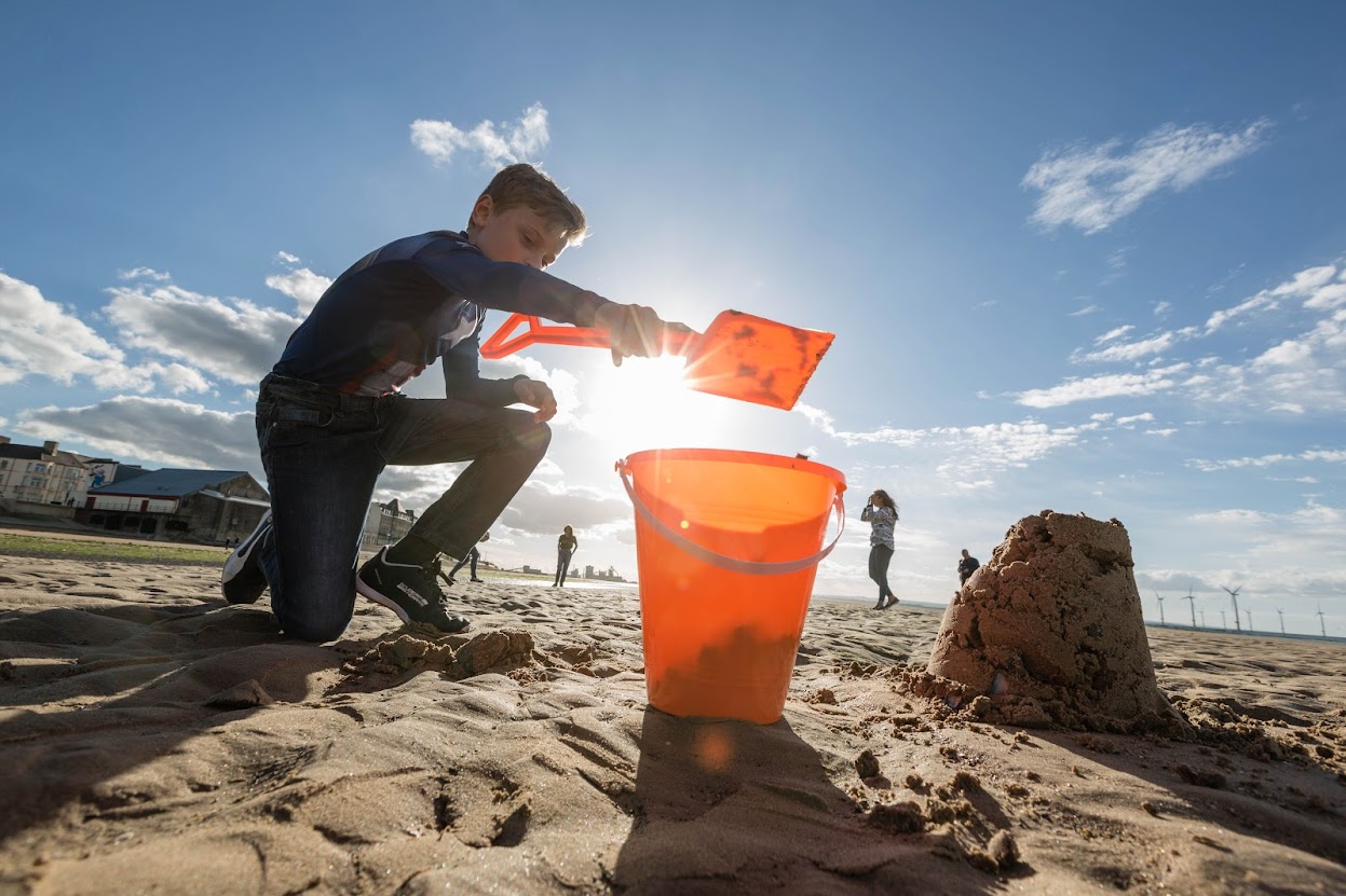 Redcar beach with child bulding sandchild